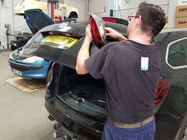 Vauxhall Astra undergoing essential pre-ITV work prior to same day test for customer from Valencia region. This vehicle need one new rear lens unit and removal of tow bar before import inspection - August 2018 