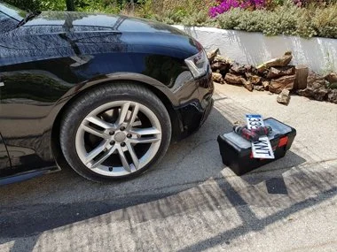 New front number plate about to be fitted to Audi A5 Coupe in Xávea, Spain. We realigned the headlights on this vehicle before successful import test in Murcia. We delivered the vehicle to our customer's hotel in Murcia city centre the same evening a
