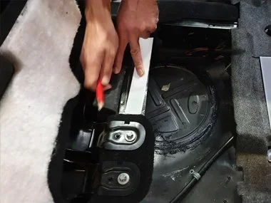 ITV technician makes etching of the stamped VIN number, located under the rear seats on Mercedes ML320 CDI during ITV import test. Our customer had purchased this left hand drive vehicle in Belgium just a few days earlier and drove the vehicle back t