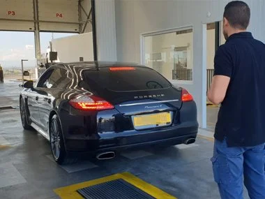 Porsche Panamera 4 Coupe has rear lights checked during ITV import inspection in Lorca. Brake lights, reverse lights, indicators and side lights are all tested to ensure compliance with Spanish vehicle regulations. This vehicle passed on all counts a