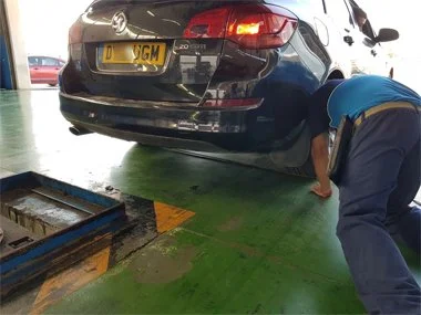 ITV technician measures rear axle width on UK registered Vauxhall Estate towards the end of the import test. This vehicle passed first time after we'd changed headlights, one rear light unit and removed tow bar - August 2018