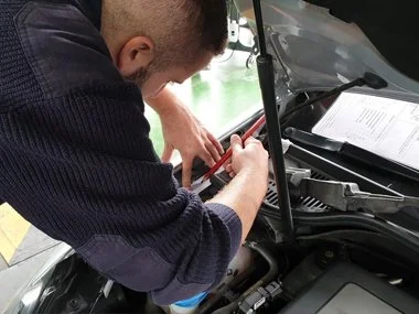 ITV technician makes etching of stamped VIN number, located on the inner wing of this 2014 Volkswagen Golf Convertible from the UK. An etching or photo of all 17 digits of the stamped VIN number is a fundamental requirement of the import test here in