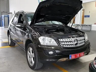 Mercedes ML320 CDI on temporary Belgian export plates awaits technical inspection during import test in Lorca. As part of the test, chassis numbers are cross referenced including the stamped VIN number, located underneath the rear passenger seat - No