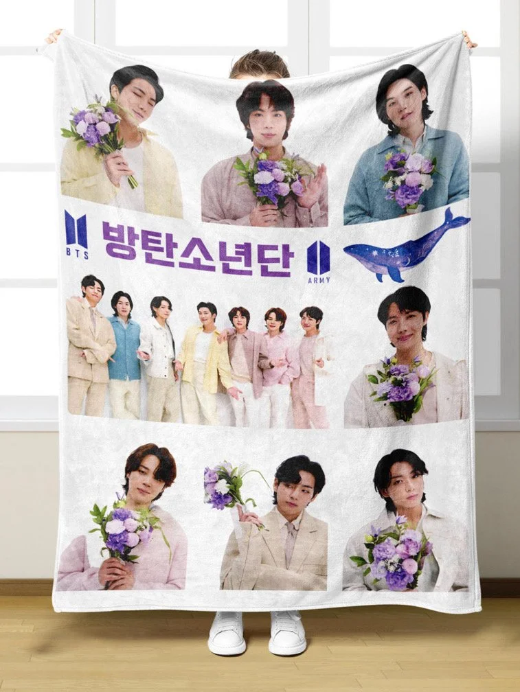A person holding a BTS poster with photos of the band members and the word BTS in Korean and English, along with a whale illustration.