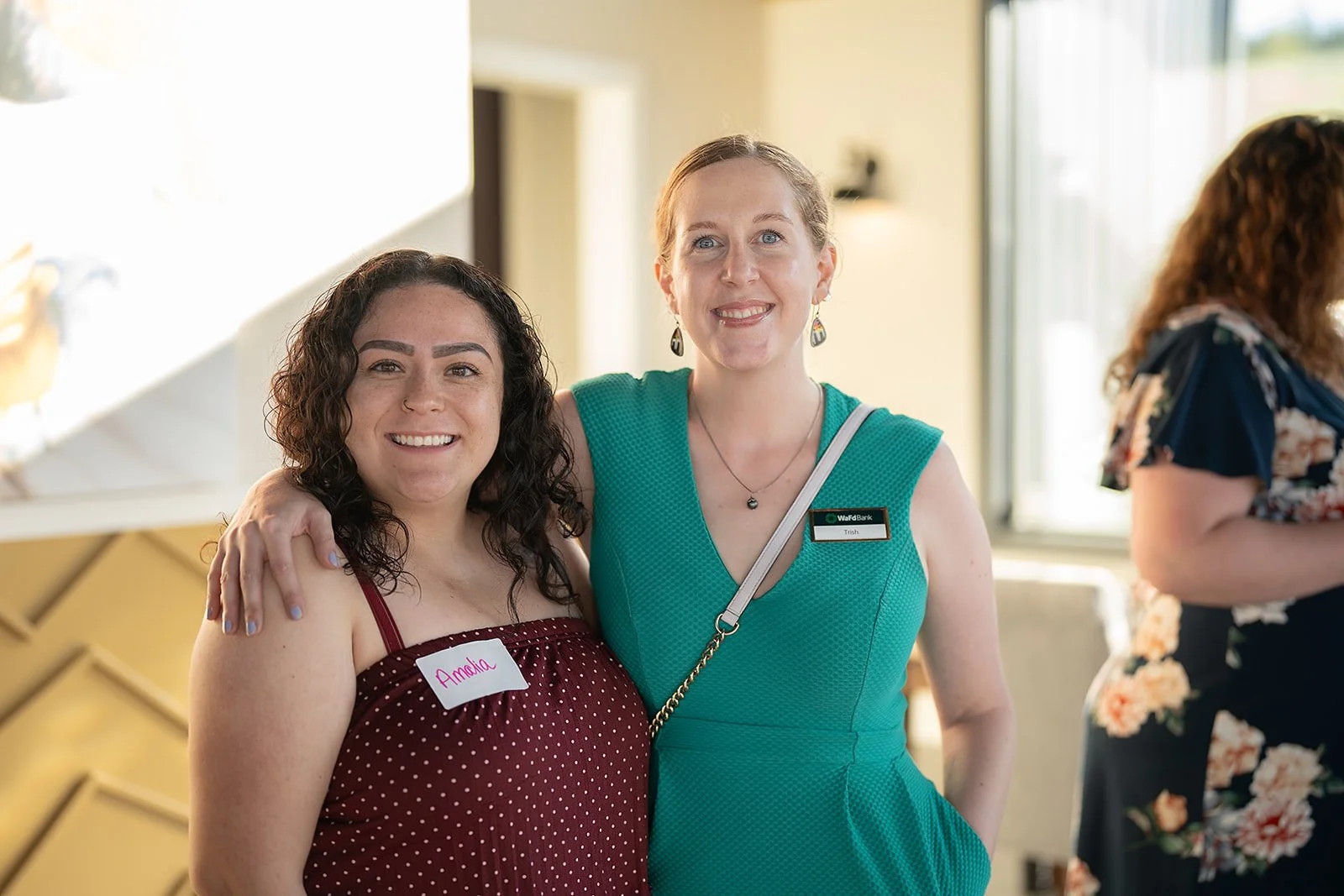 Two women smiling at a Rogue Valley Women in Business event.