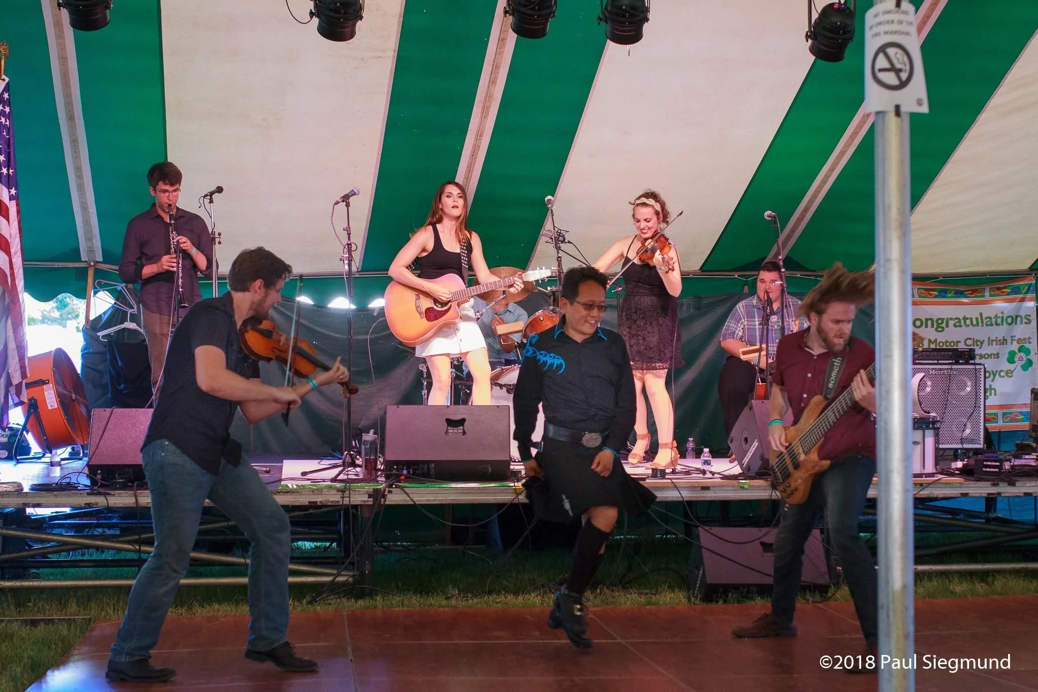 Marcel performing improvisational Irish fusion dance with a live band at a festival