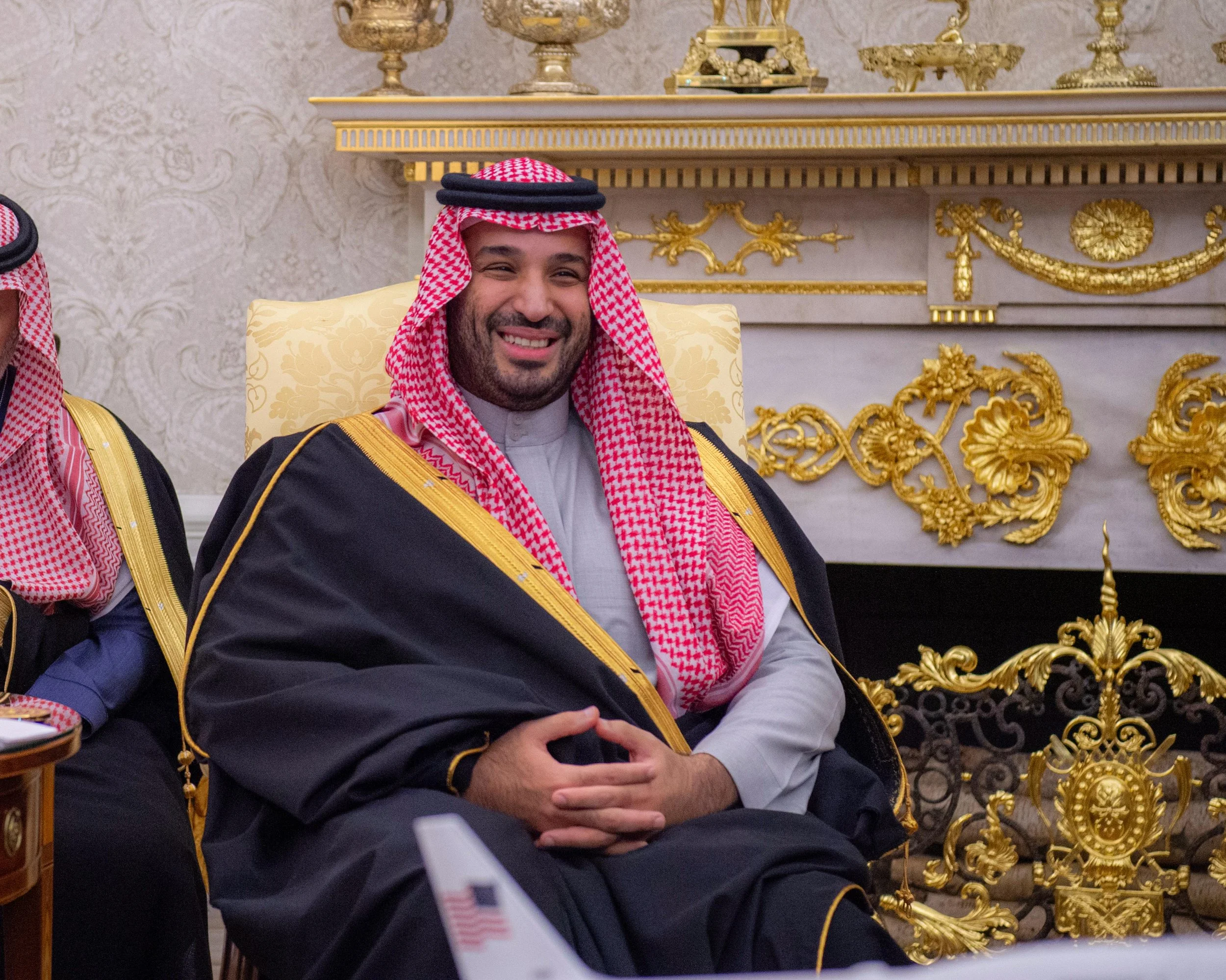 Formal image of Mohammed bin Salman Al Saud seated in traditional Saudi attire during an official meeting