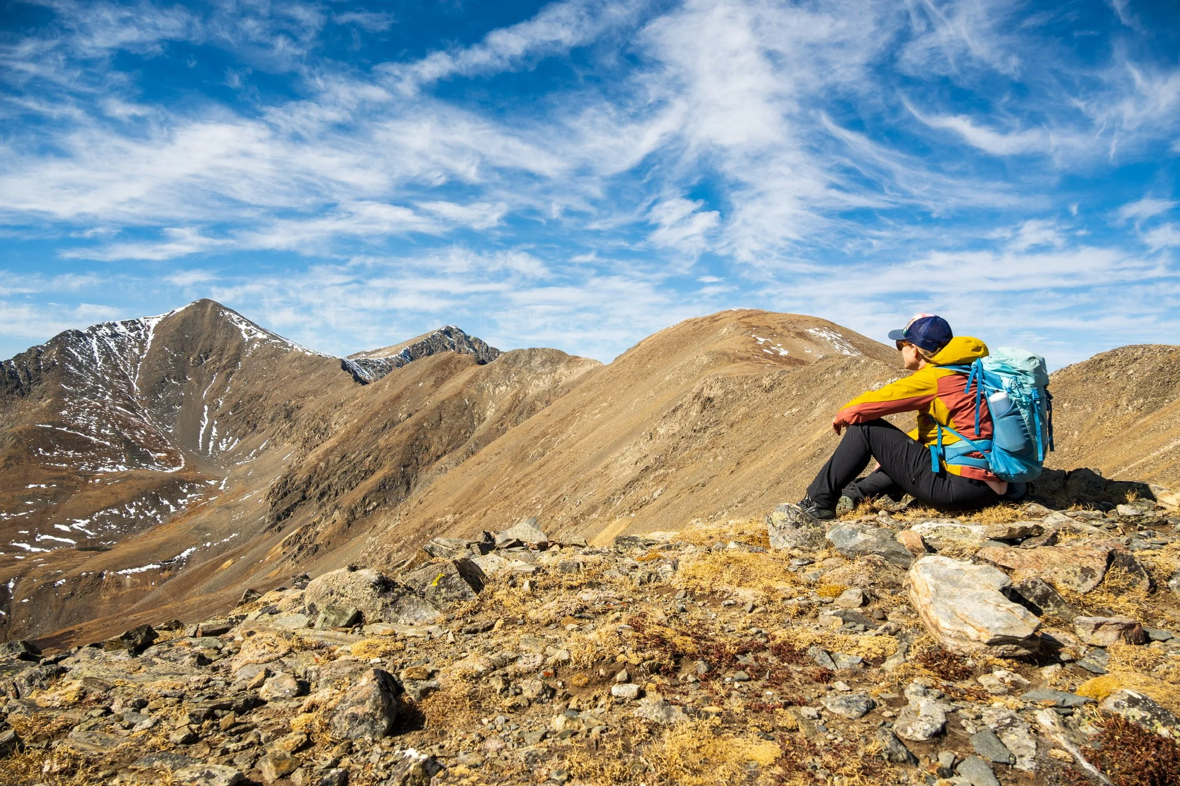 Caley Van Cleave, abstract landscape painter, resting at the summit near Minturn, Colorado. Photo credit to Kevin Ingham.
