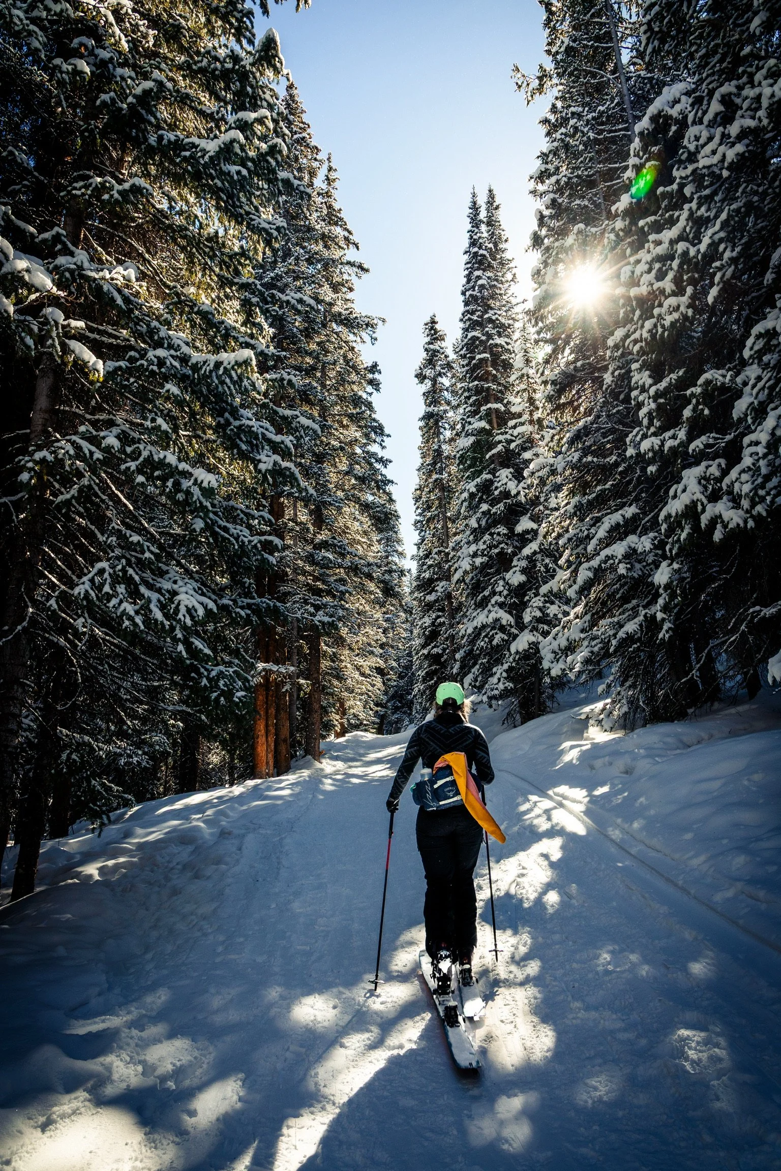 Caley Van Cleave, abstract nature painter, backcountry skiing the Mayflower Gulch trail just outside of Copper, Colorado. Photo credit to Kevin Ingham. 