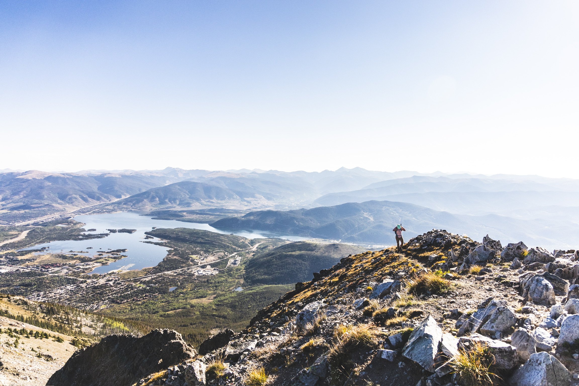Caley Van Cleave, contemporary landscape painter, cresting the top of Peak One hike of the Ten Mile Range in Frisco, CO just after sunrise. Photo credit to Kevin Ingham. 