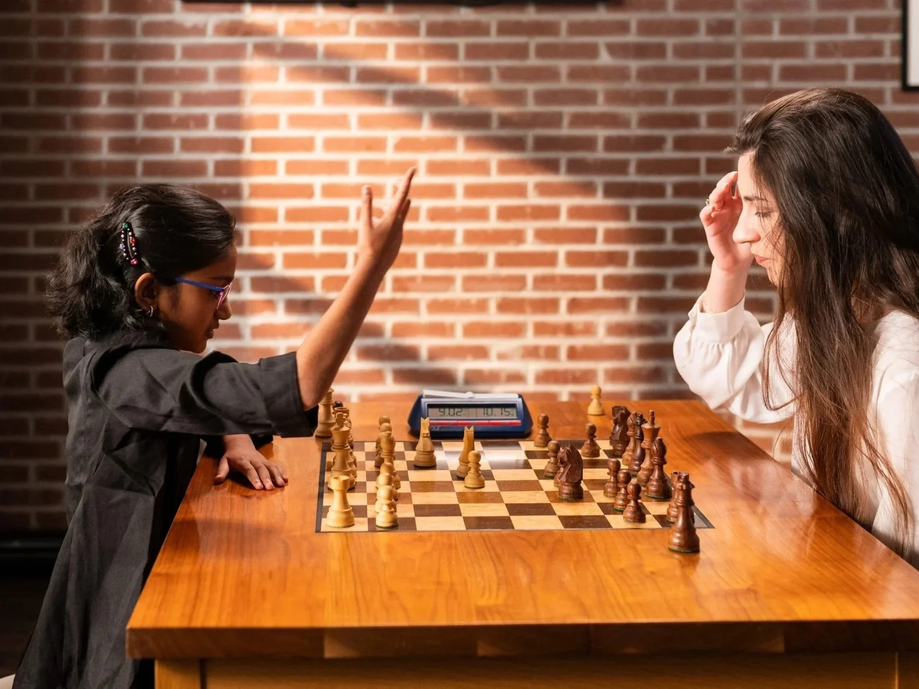 A young girl receiving a private coaching session with a woman grandmaster