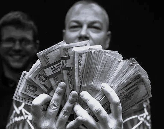 Scott Frost holding his winnings after a major payout in professional pool — over 35 years at the highest level