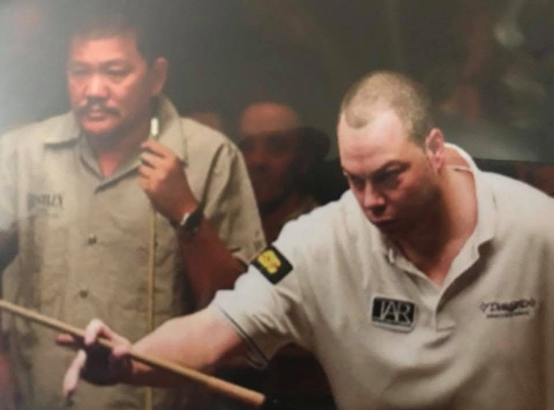 Scott Frost at the table with Efren Reyes looking on