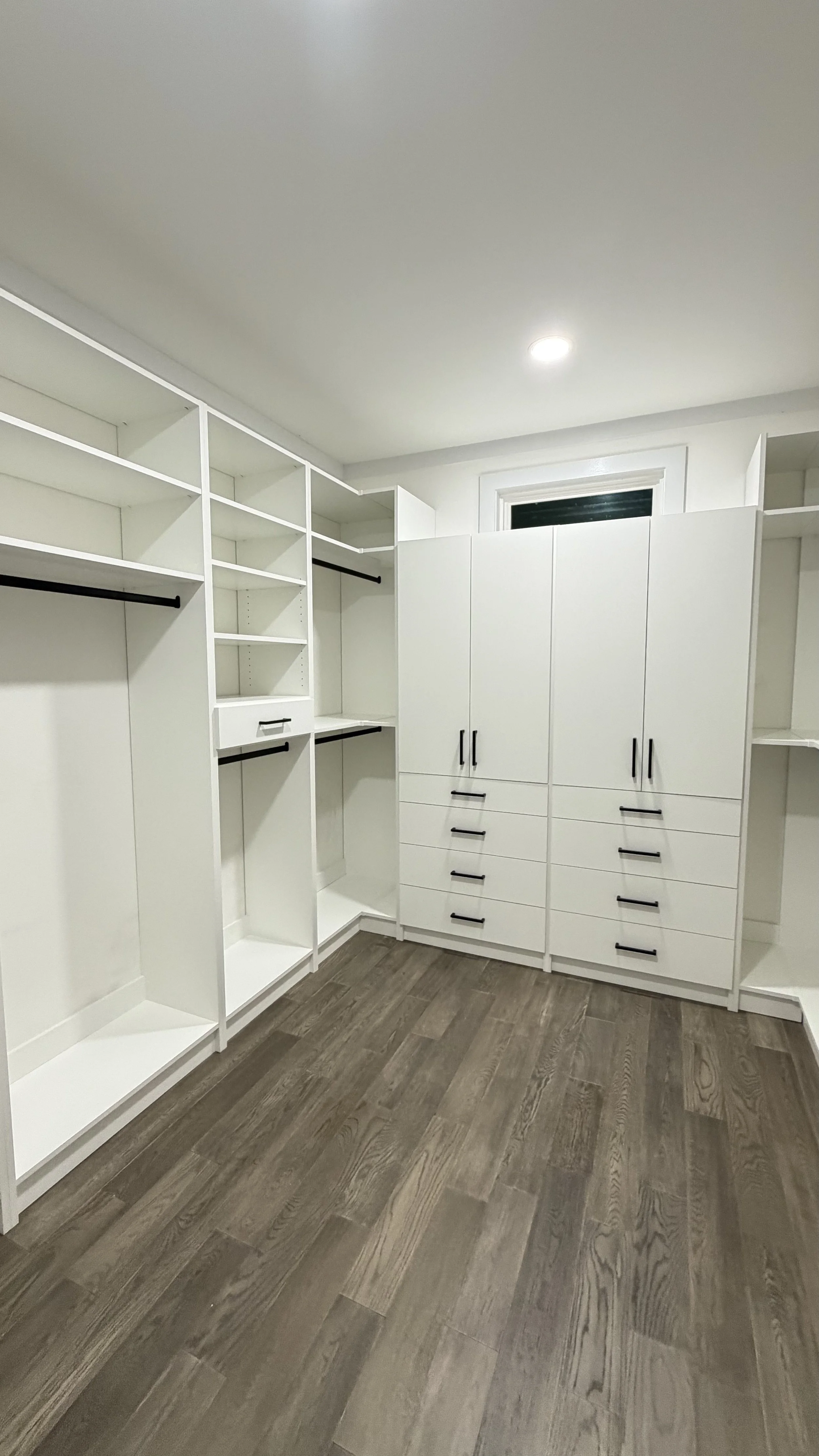 Master walk-in closet with integrated wardrobe with depth 20 inches and adjustable shelves.