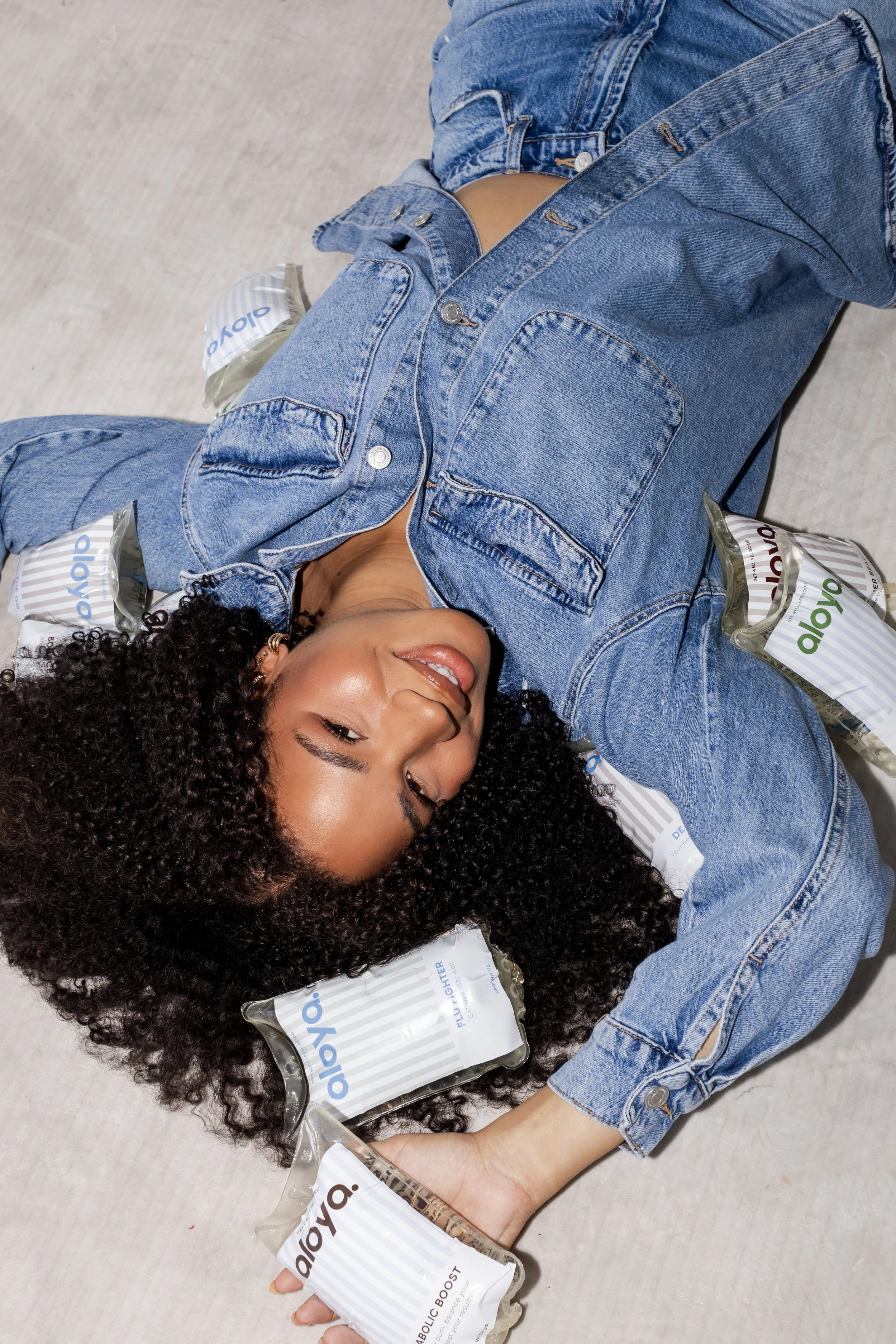 Branding photoshoot in Toronto for a wellness company featuring model with beauty products in a playful, editorial setting.