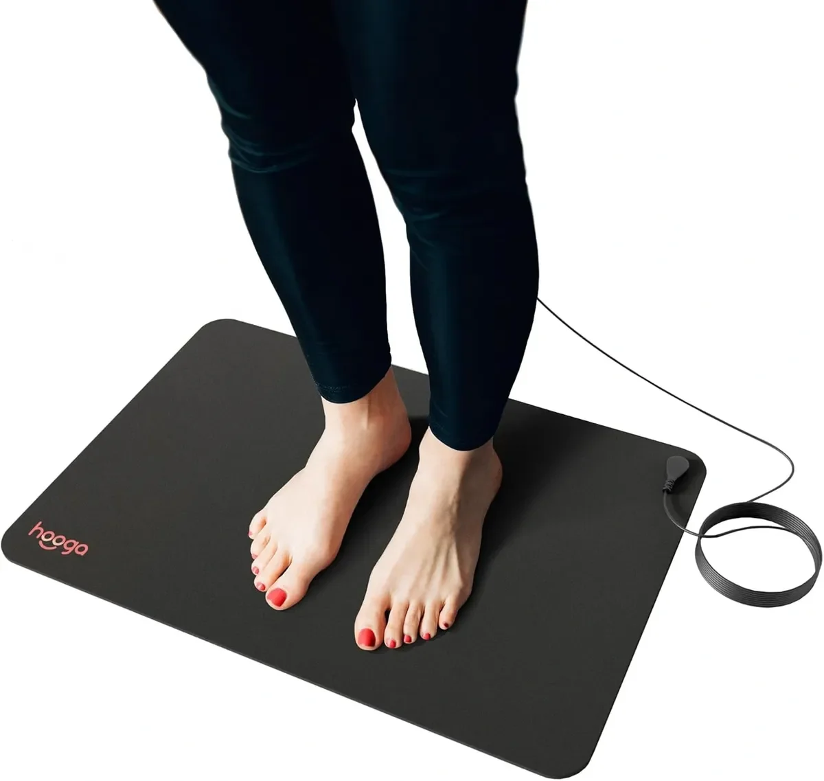 Person standing barefoot on a black digital balance with the brand name 'hugo' in pink, wearing dark pants, on a plain white background.