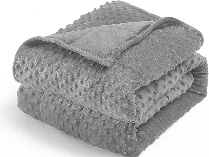 A neatly folded set of gray textured blankets with a matching smaller blanket or towel on top, all placed on a white background.