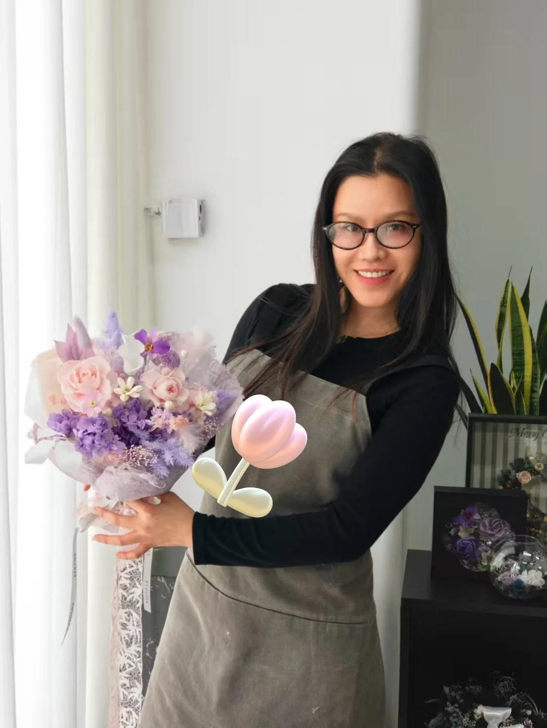 Photo of business owner Sarah Wen holding flowers and smiling