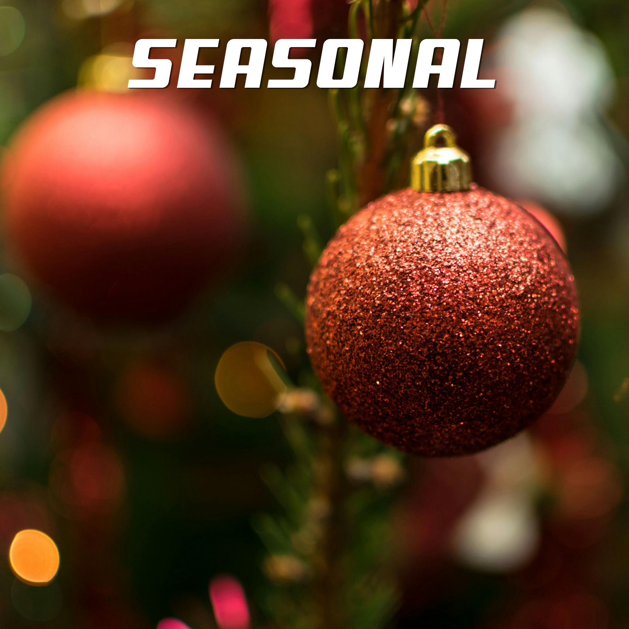 Close-up of a red Christmas ornament with a glittery surface hanging on a Christmas tree, with blurred colorful lights in the background.
