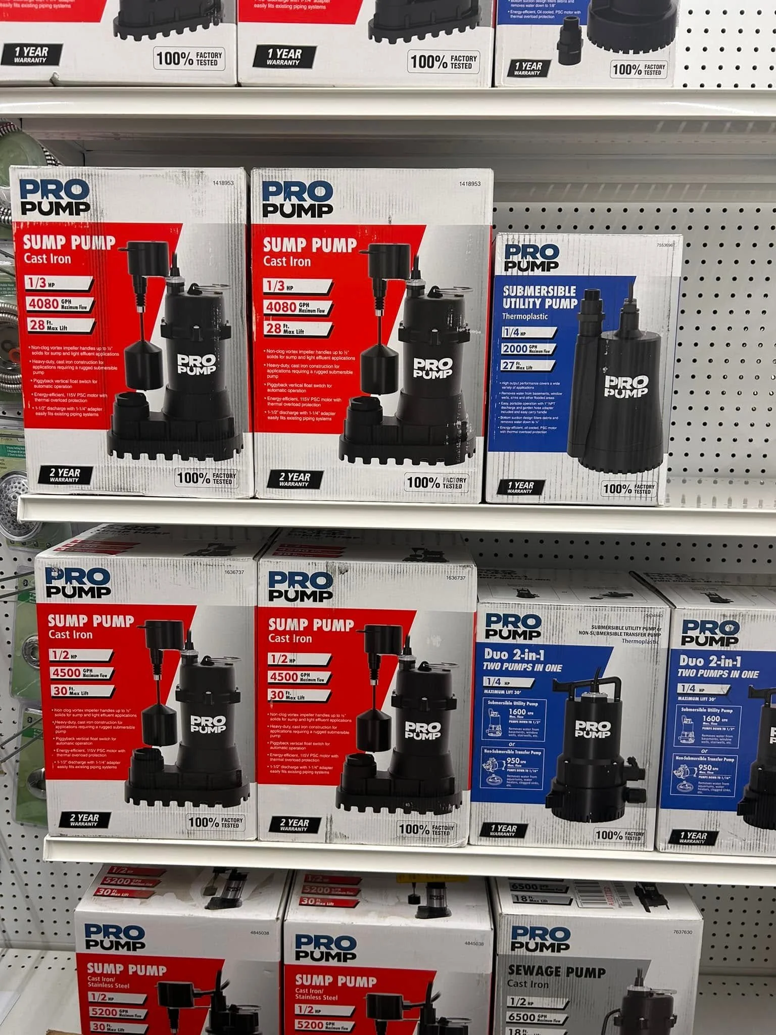 Boxes of Pro Pump sump pumps and submersible utility pumps on store shelves, showing various models and specifications.