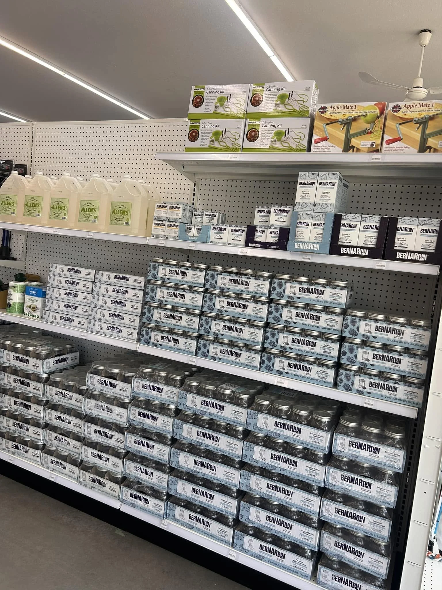 Store shelf displaying canned tuna fish labeled 'Bernardin' stacked in rows.
