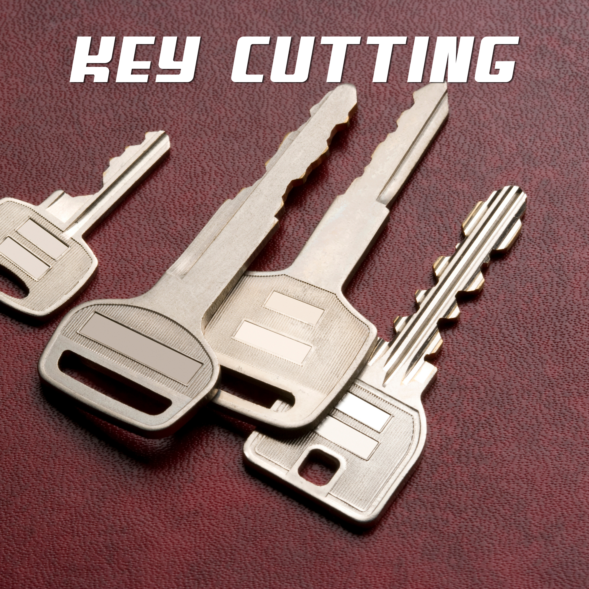 Close-up of several metal keys on a red textured surface, with the words 'Key Cutting' overlayed at the top.