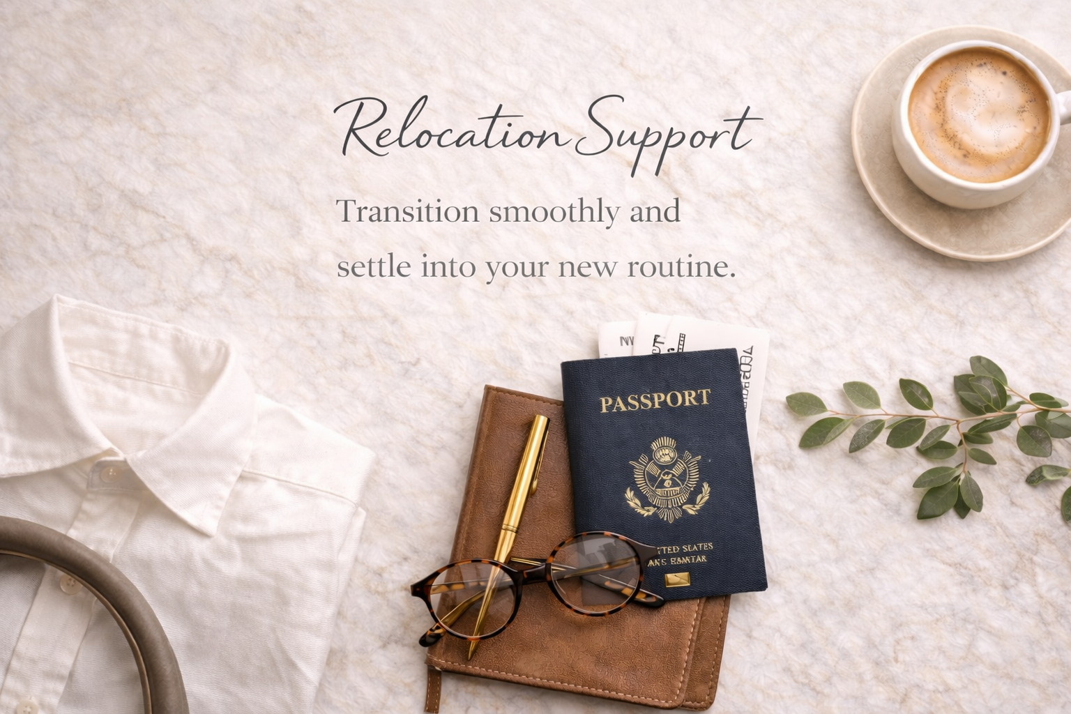 Travel essentials on a beige textured surface including a white shirt, sunglasses, a gold pen, a brown leather notebook, a US passport with boarding passes, a sprig of green leaves, and a cup of coffee in a white mug with a saucer.