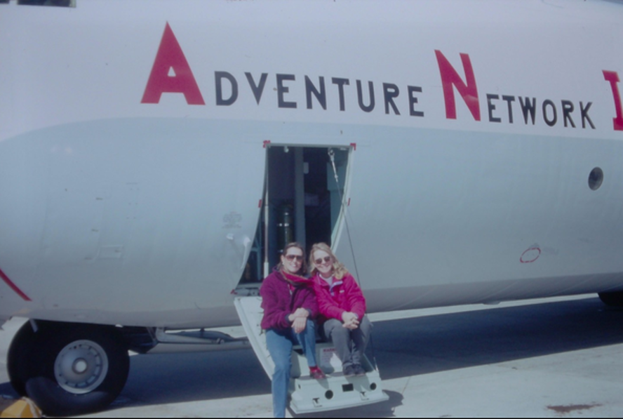 Anne Kershaw and friend sti on the steps of an Adventure Network International aircraft.