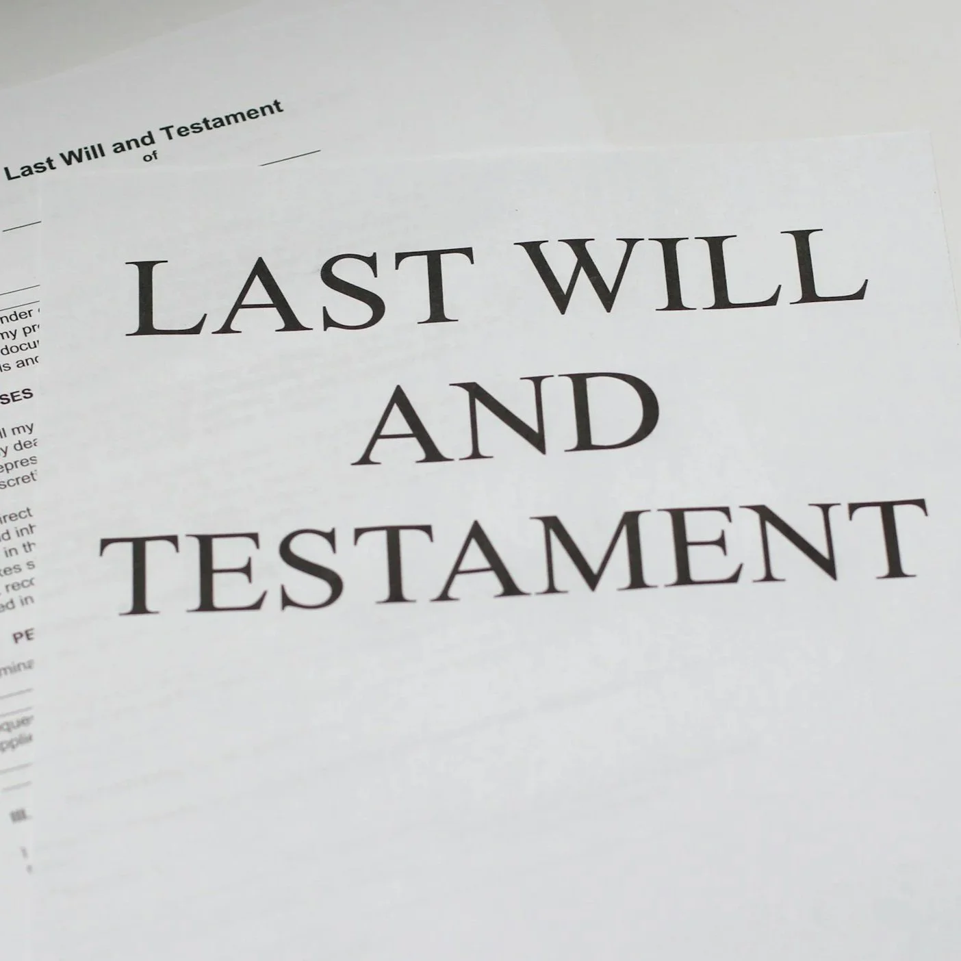 Close-up of a document titled "Last Will and Testament" with the words "Last Will and" in bold, over a page of text.