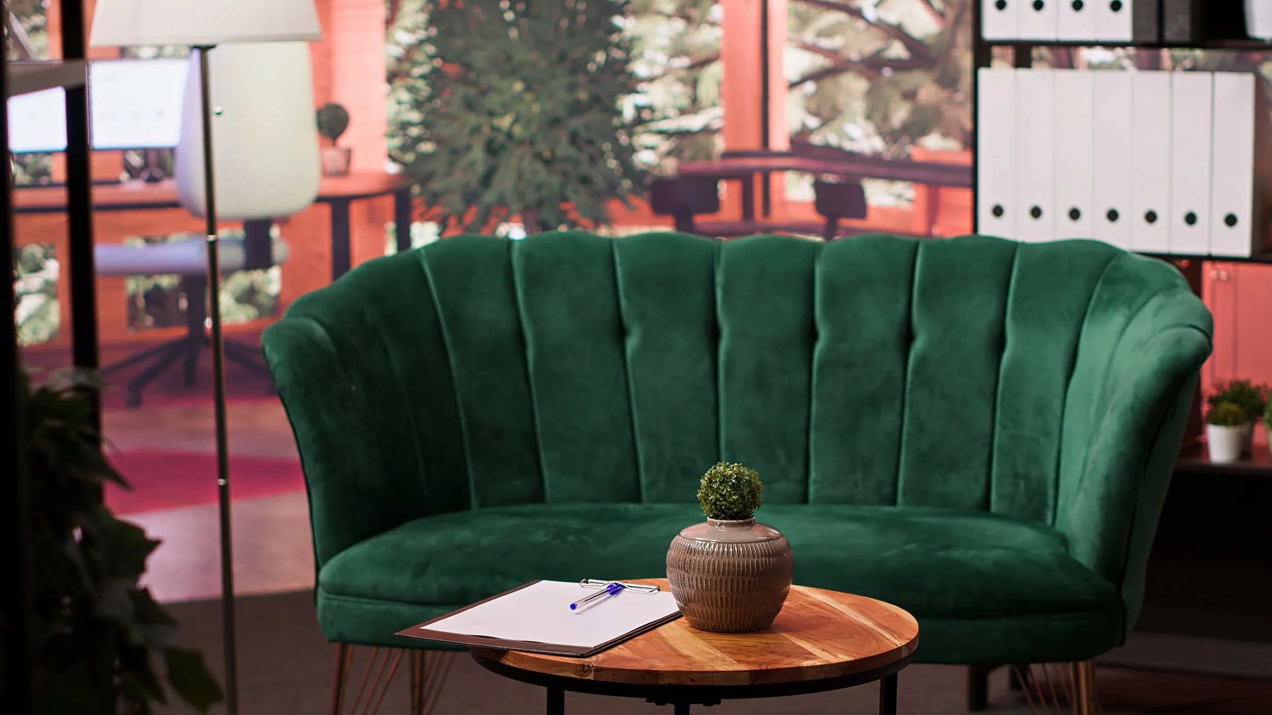 Comfortable therapy office with green couch and seating area for counseling sessions