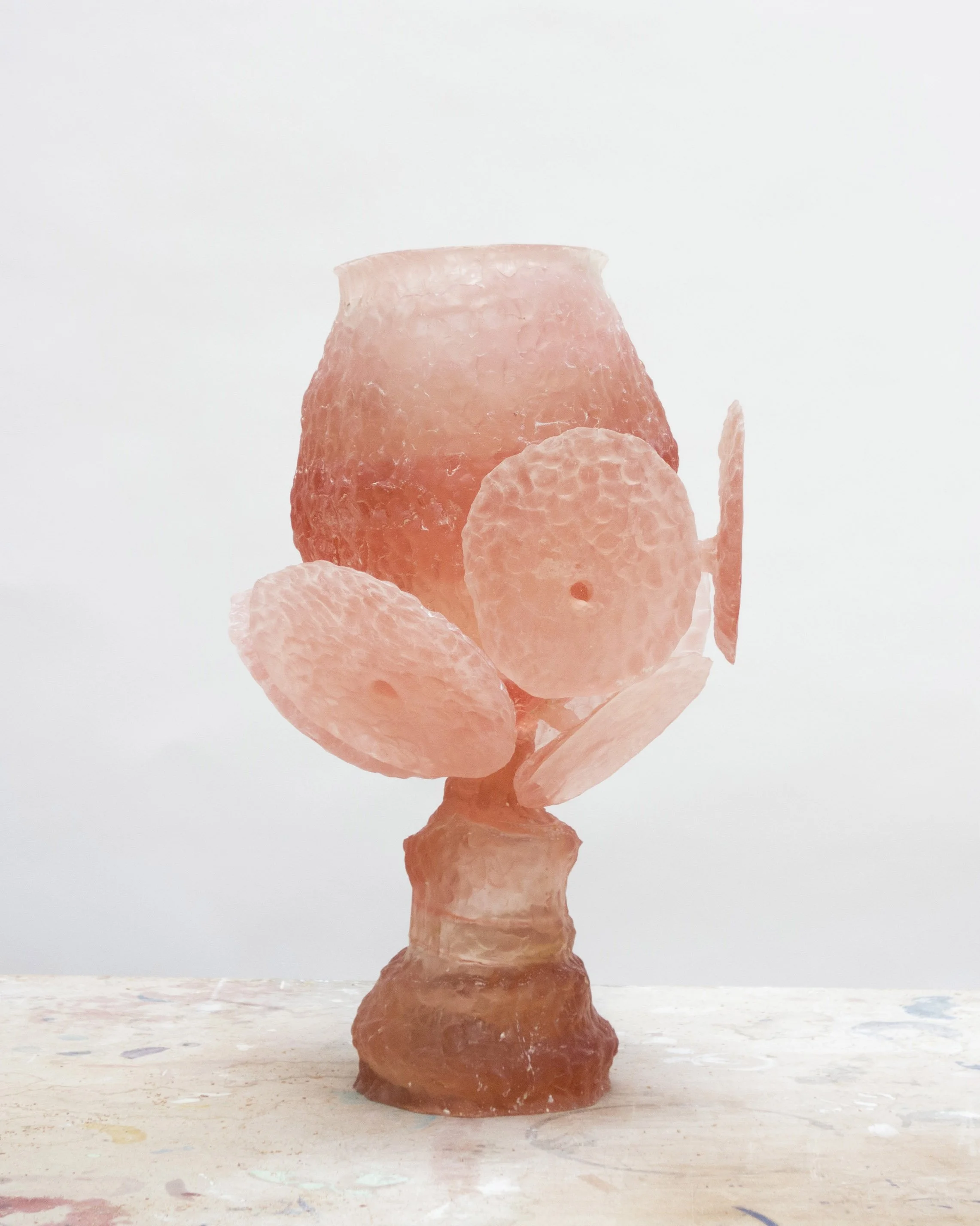 Salt lamp sculpture resembling a stylized human figure, with a core made of pink salt and parts of the salt sculpture shaped to suggest the head and body.
