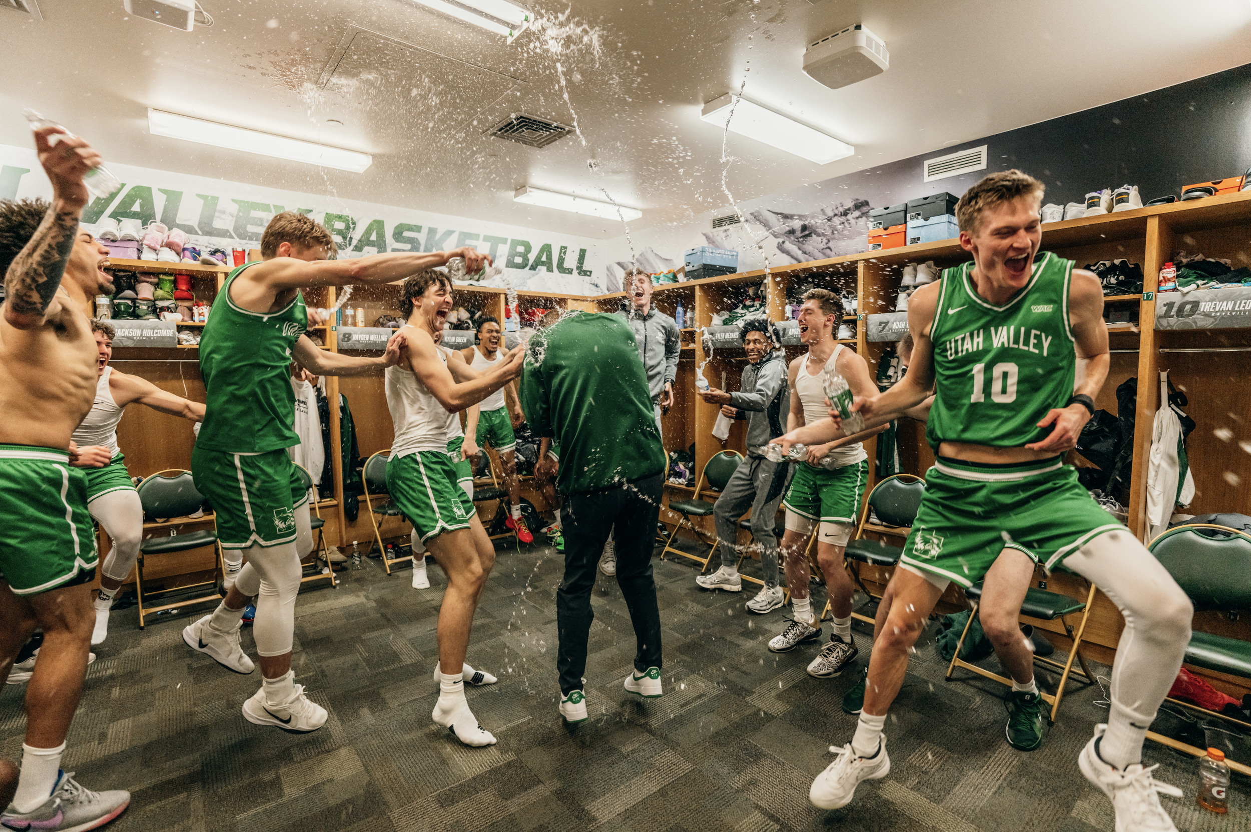 The UVU Men's basketball team celebrate by dousing the coach after season of no losses at home. 