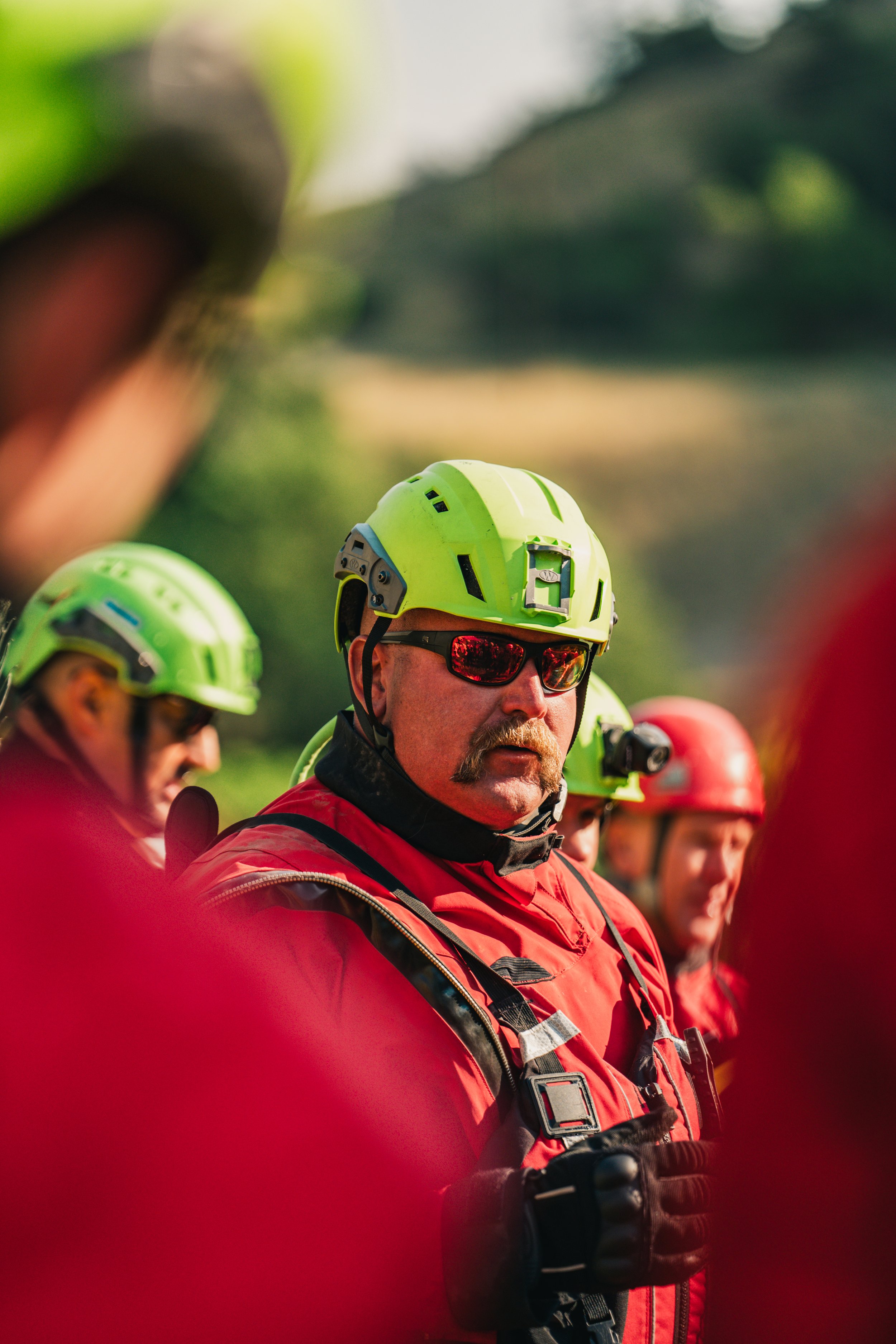 An instructor explains the next scenario at a swift water rescue training.