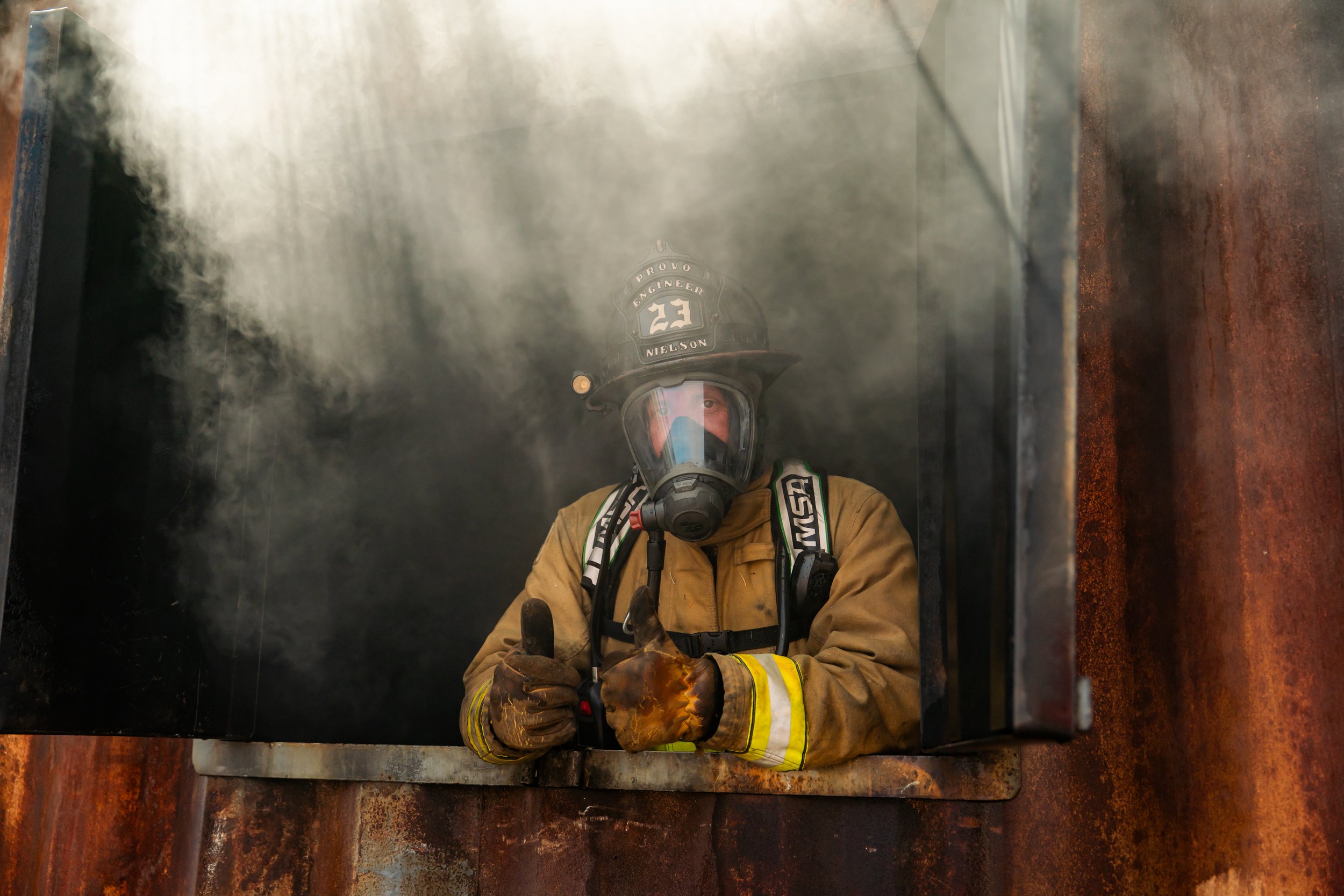 An instructor gives the camera a thumbs up as he stoked the training fire.