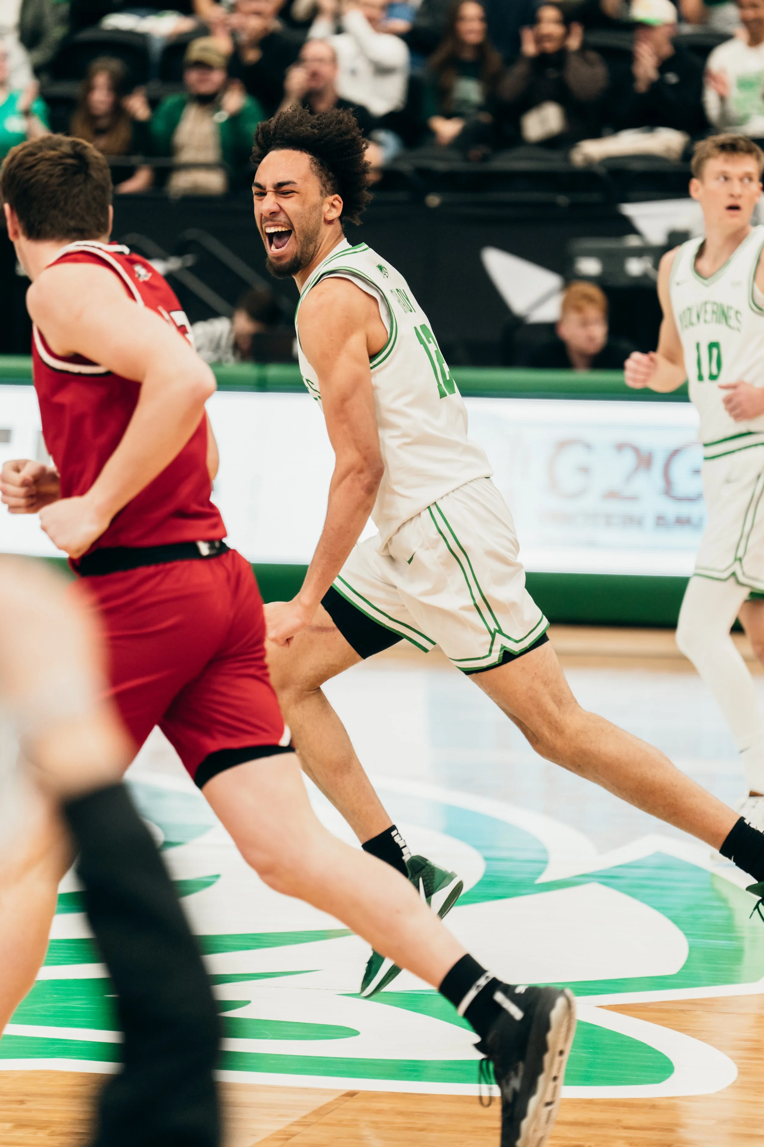 Player on the UVU Men's basketball team celebrated after making a shot