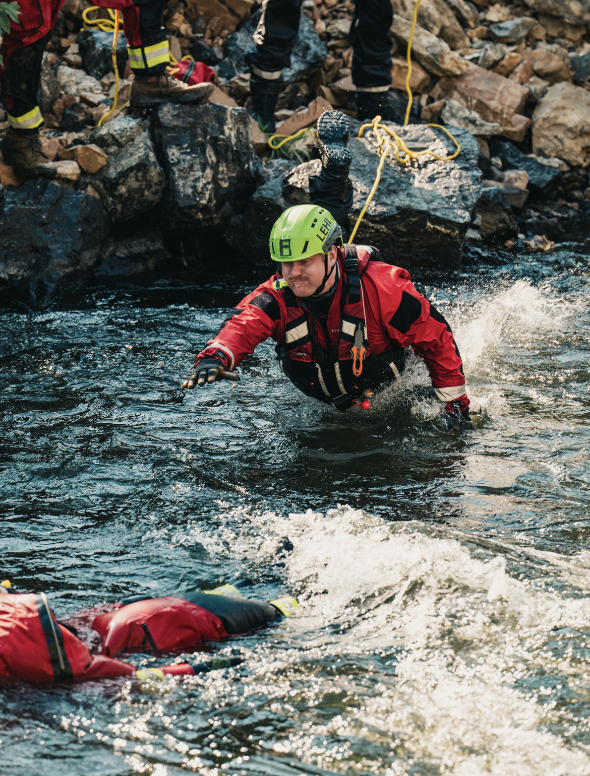 A rescuer leaps to a the river during a swift water rescue training.