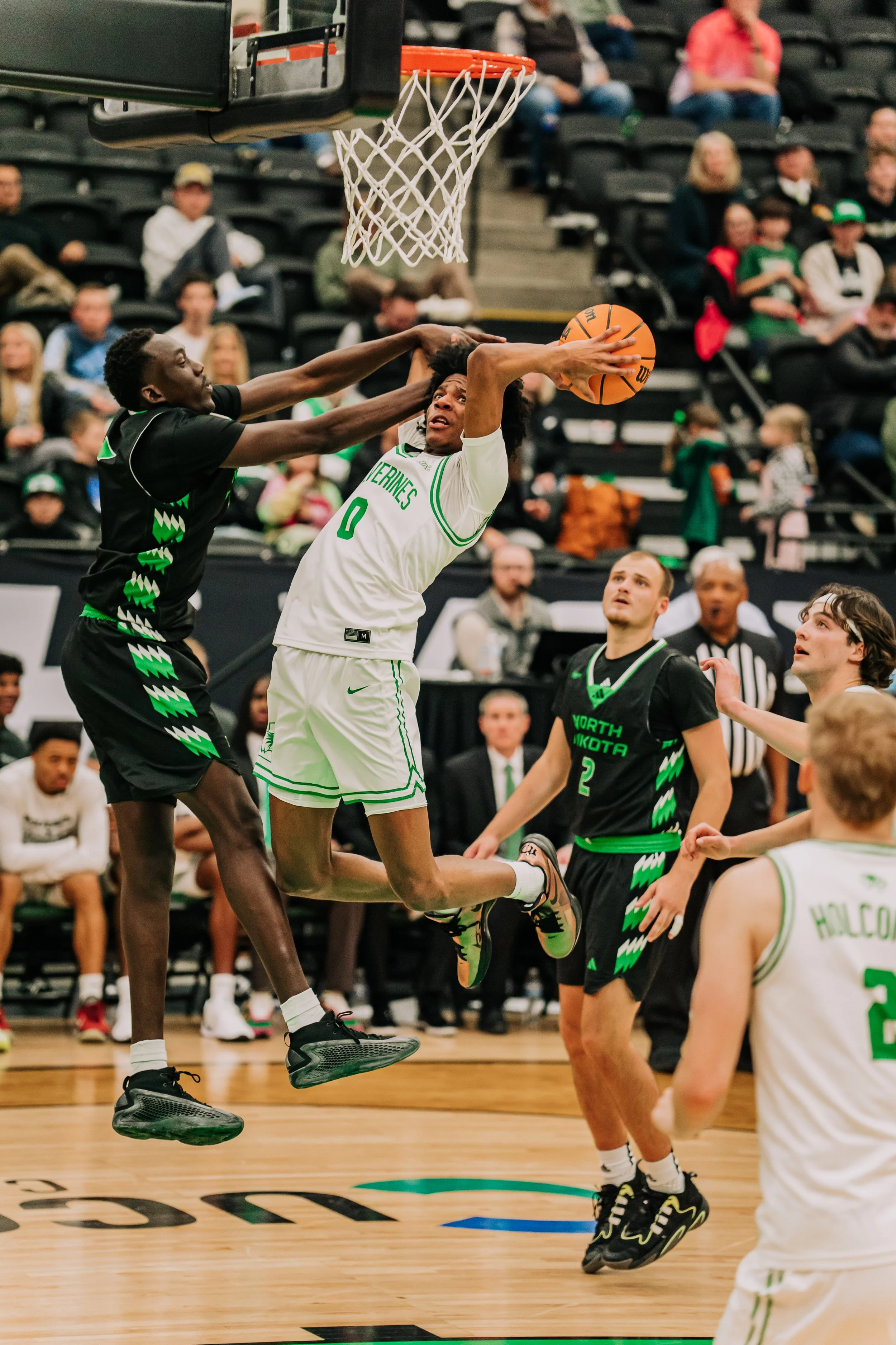 UVU Men's Basketball player leaps in to the air while attempting a layup. 