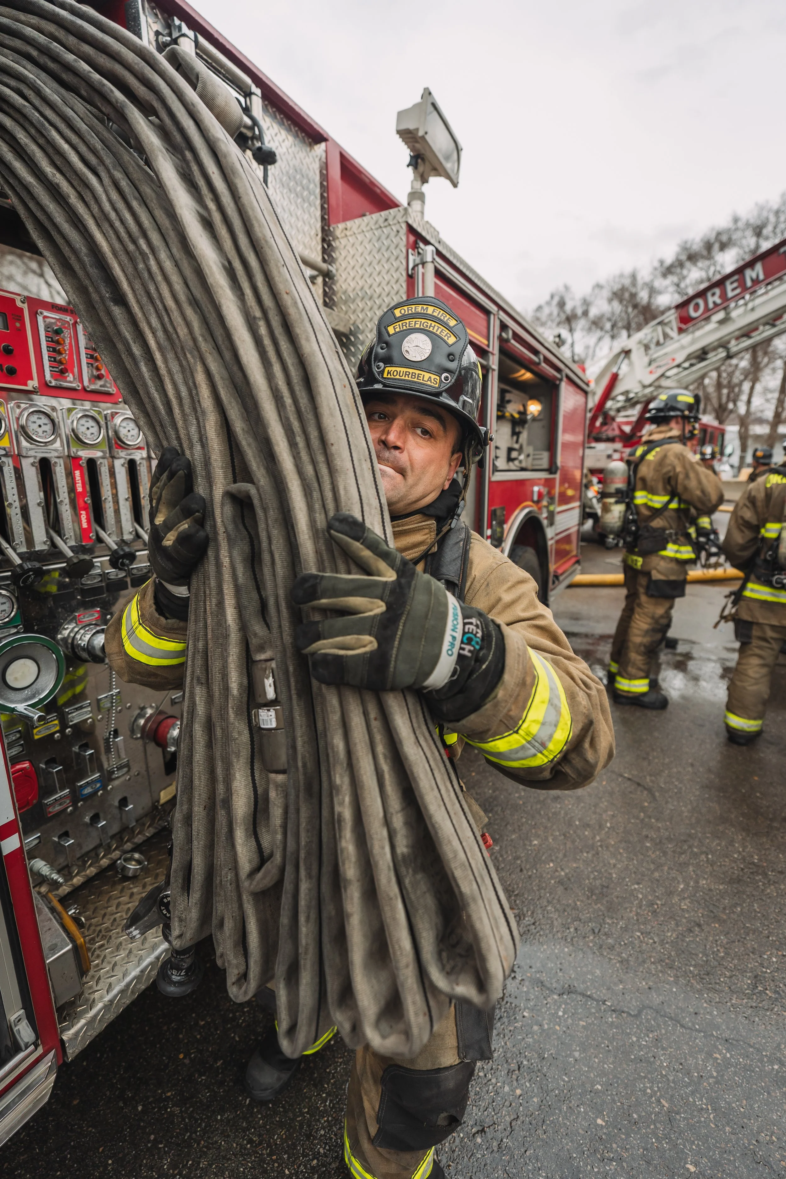 A firefighter grabs a line of hose