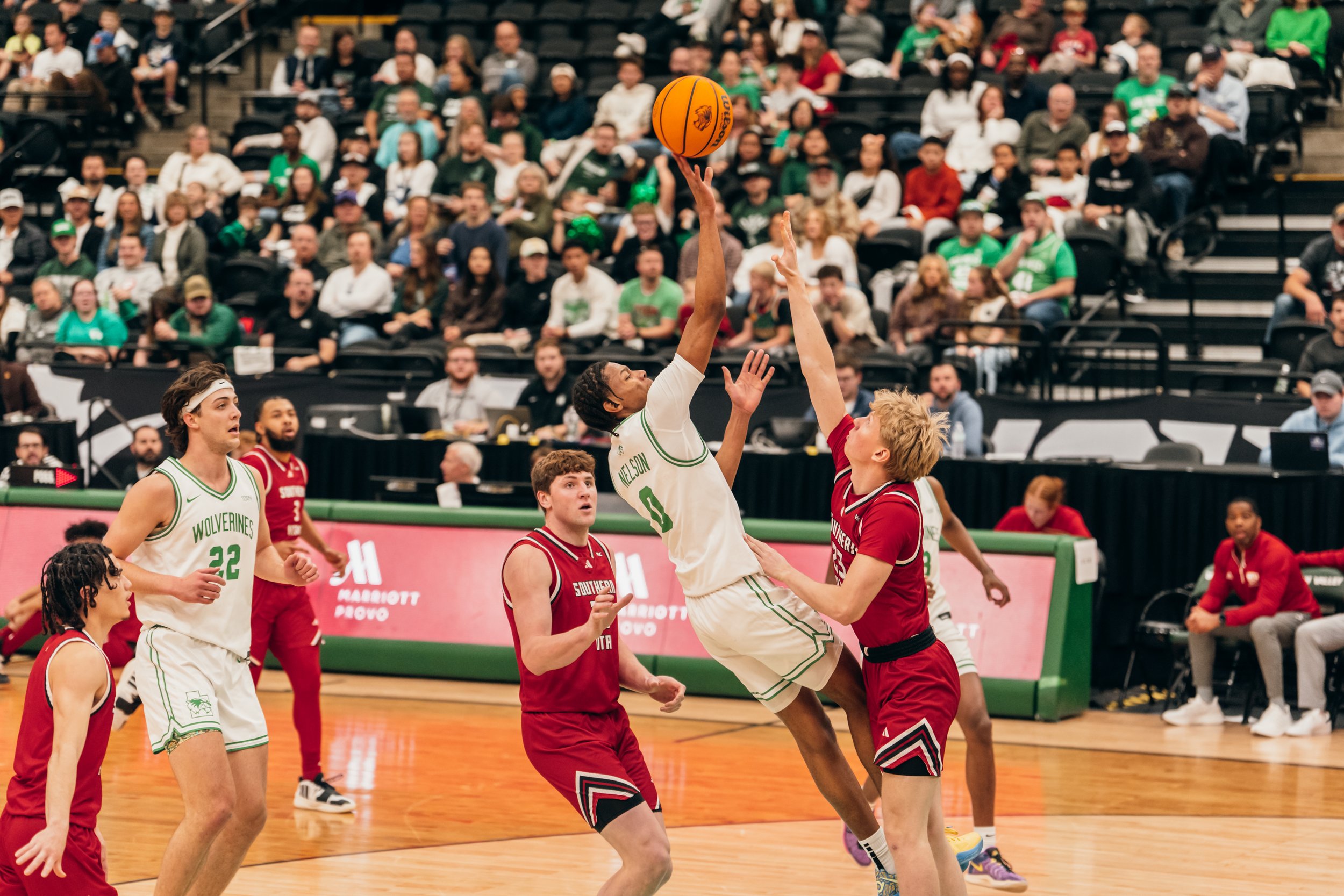 A UVU Men's basketball player displays a light touch while being defended. 