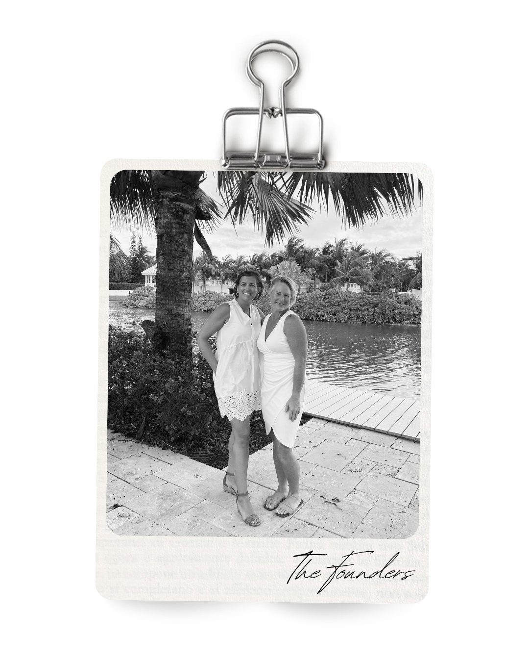 Two women in white dresses smiling and standing together near a body of water with palm trees in the background, labeled 'The Founders'.