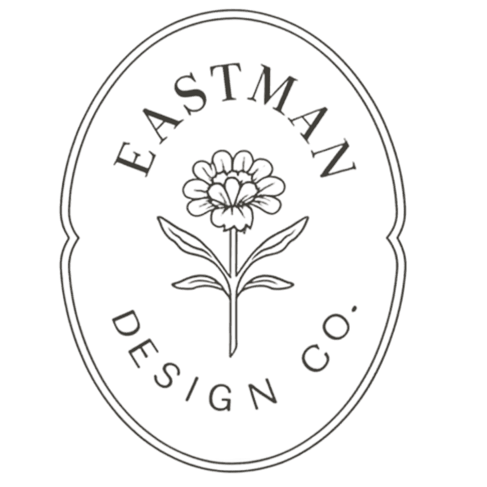 A black and white logo with the text 'EASTMAN DESIGN CO' surrounding a stylized flower illustration.