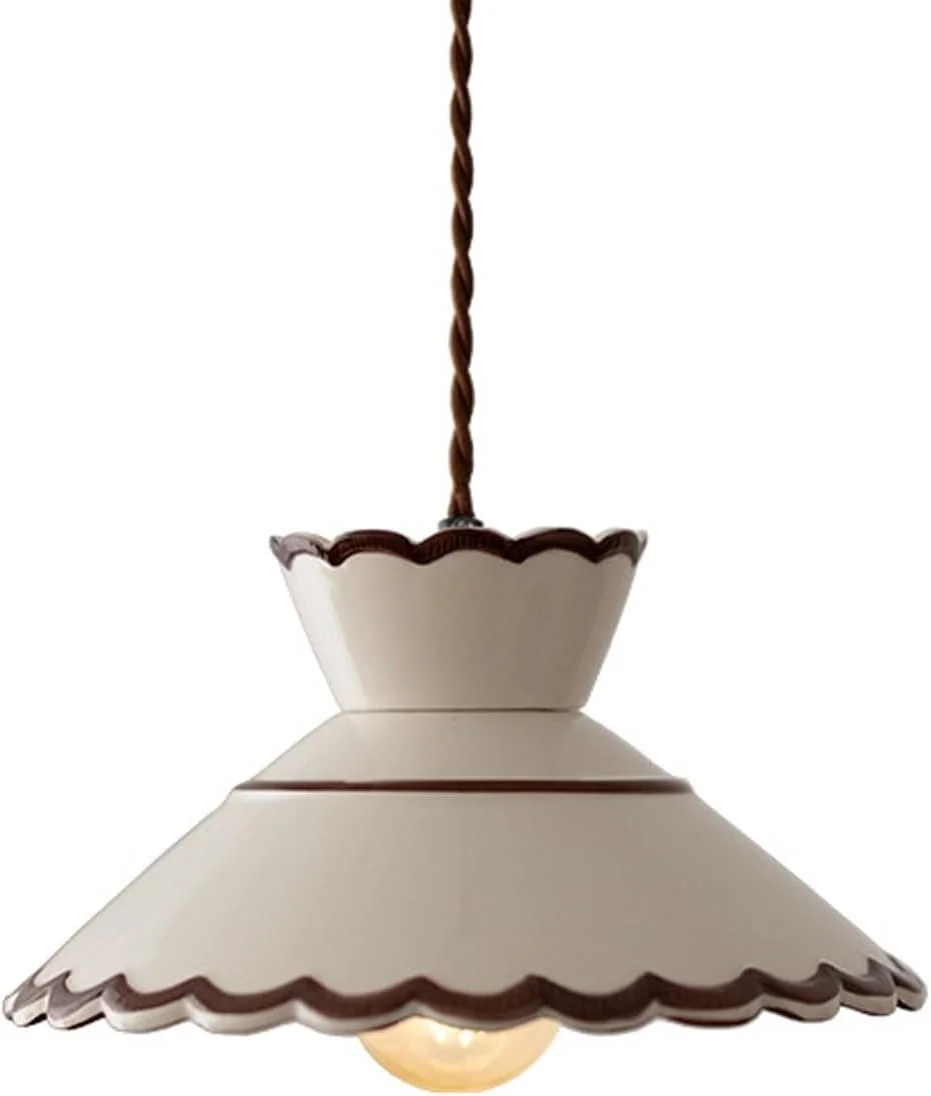 A vintage hanging pendant lamp with a scalloped white shade and brown trim, illuminated.