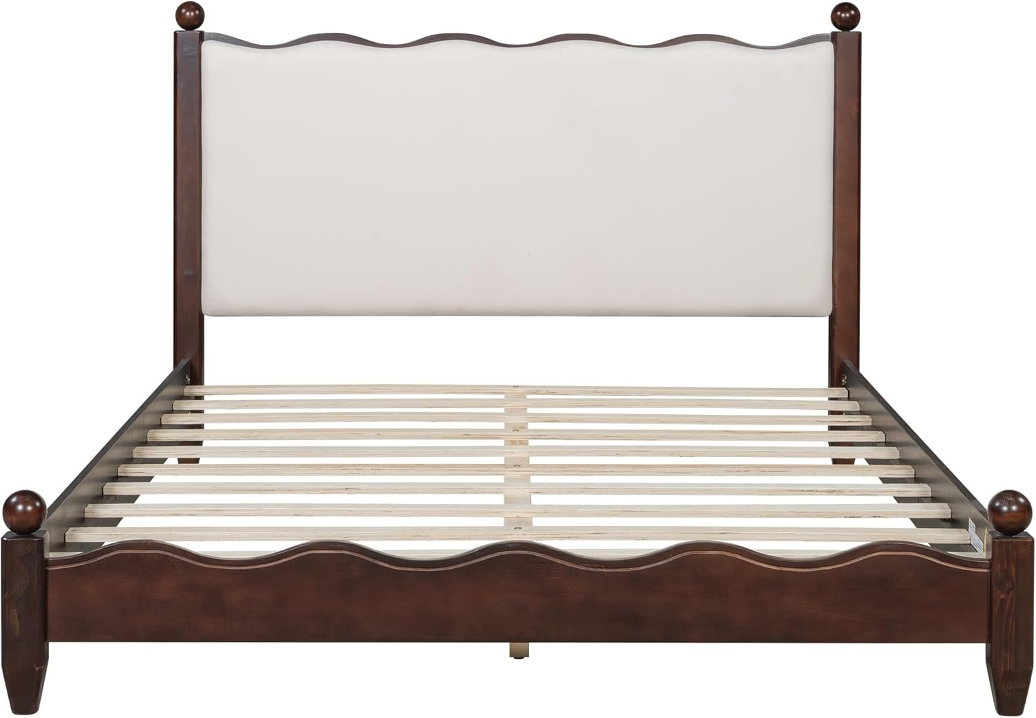 A wooden bed frame with a white padded headboard and slats for mattress support, view from front.