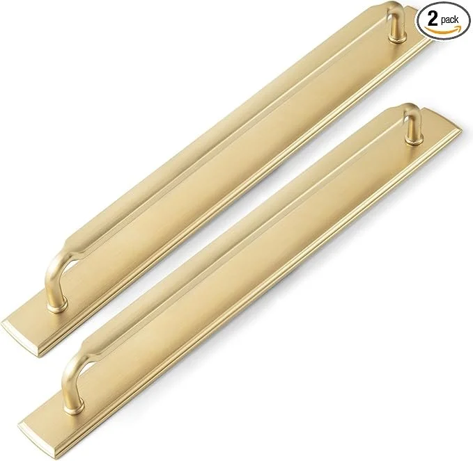 Two gold-colored door pulls with curved handles on rectangular backplates, packaged as a two-pack.