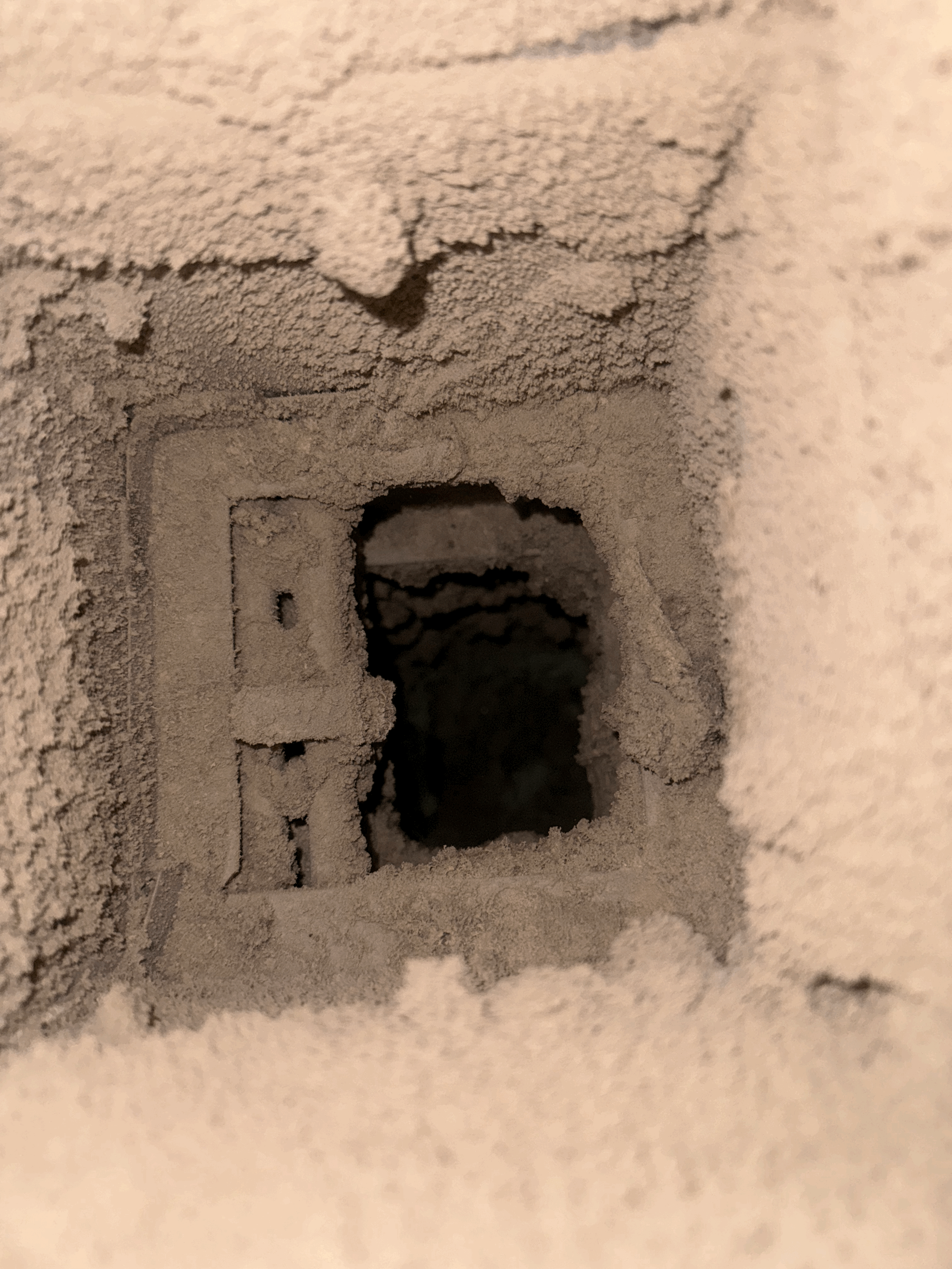 Close-up of a return vent visible dust debris in ductwork  This is before cleaning