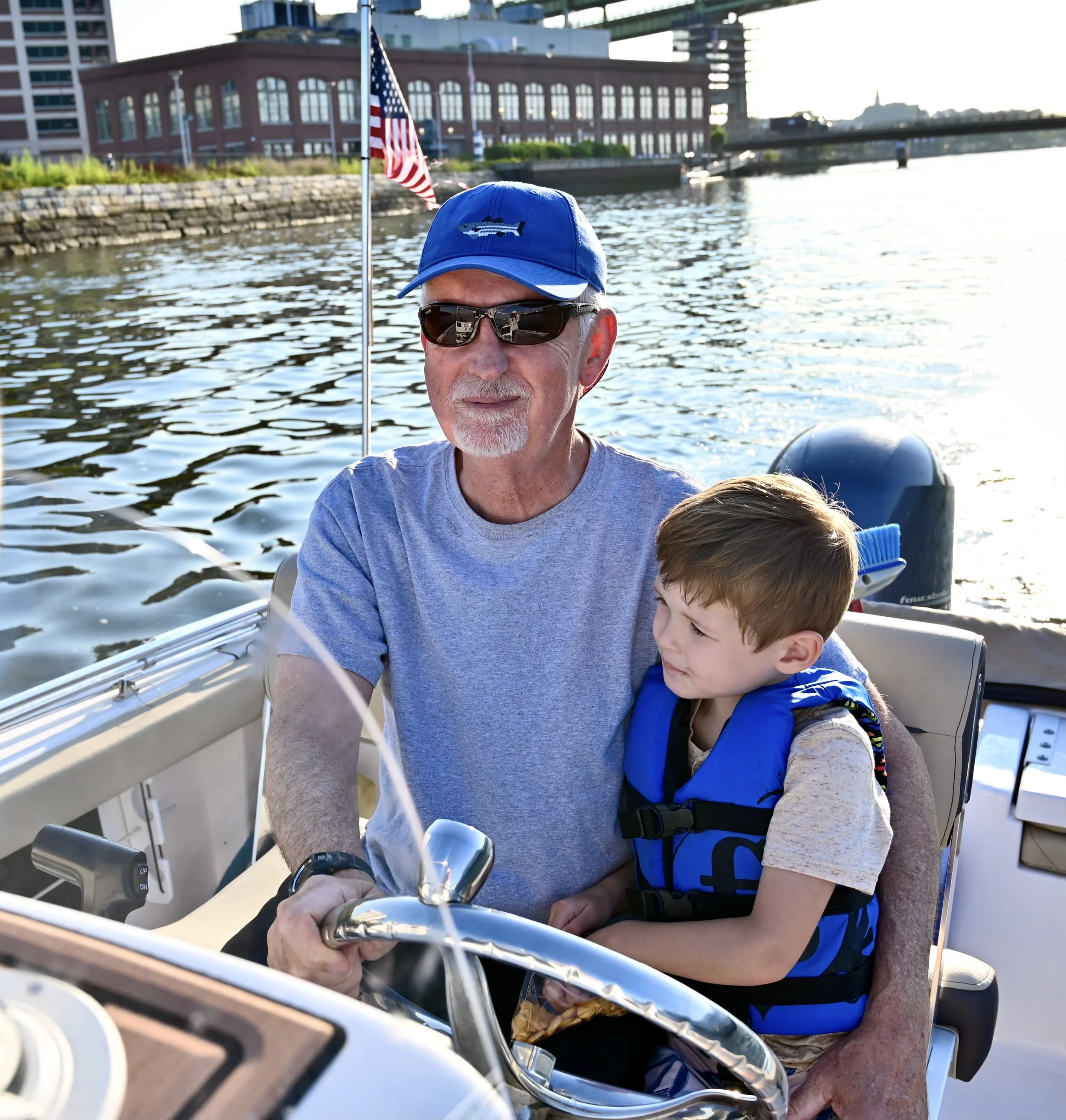 Tom on the boat with his grandson