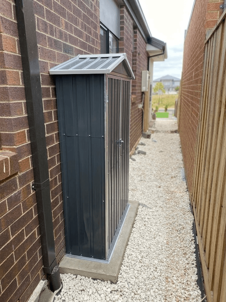 Steel storage shed installed in tight side passage on concrete footing, Rosanna