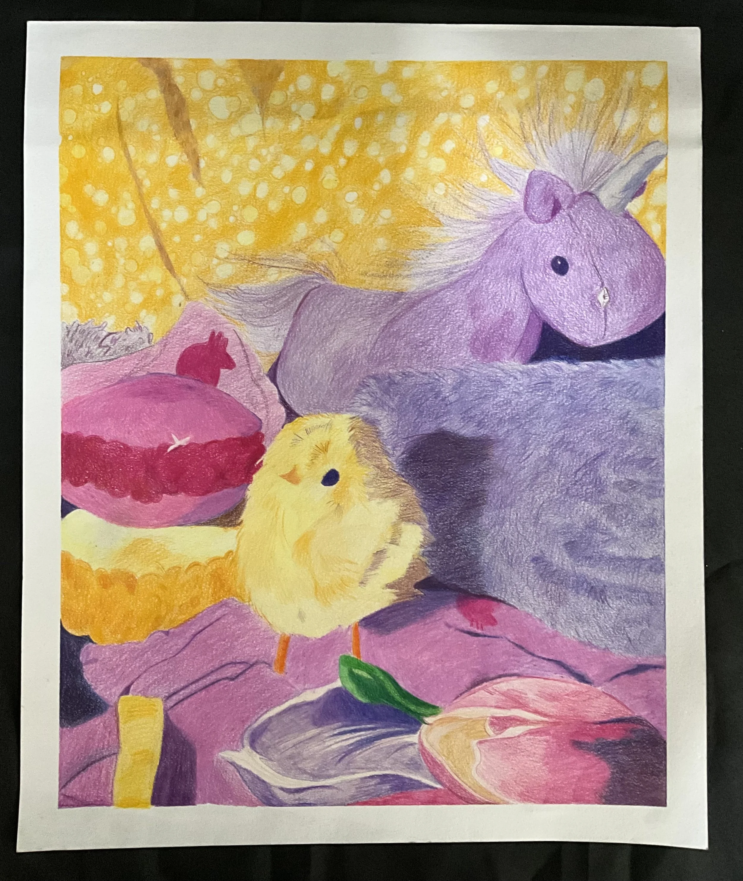Colorful drawing of a yellow chick, and a purple unicorn resting on a pink blanket with an orange and pink flower in the foreground. The background features a yellow pattern with white dots.