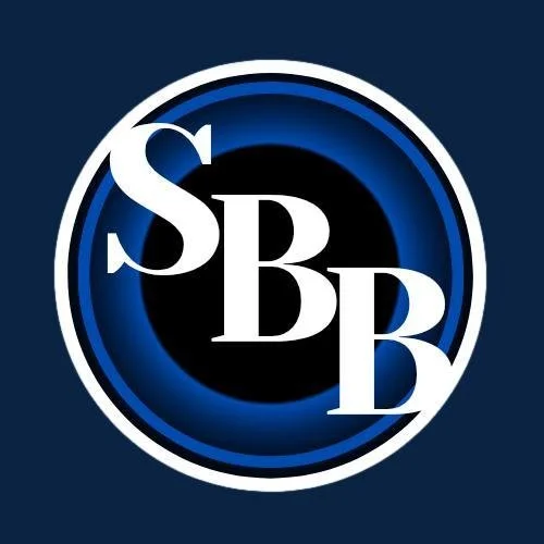A logo with the letters S, B, B inside a circular border with a blue and black background.