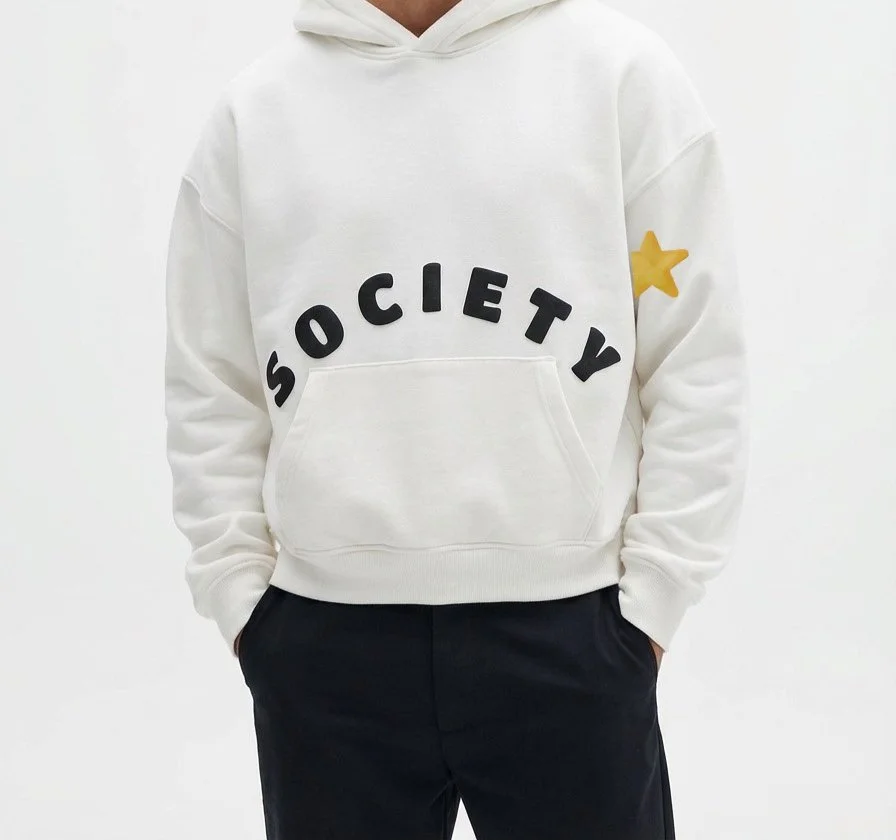 White Hoodie studio study — cropped silhouette with black puff SOCIETY lettering.